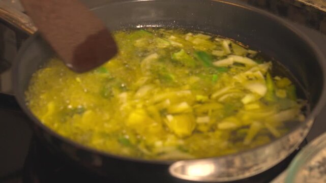 Sauteing leeks and spring onions in sizzling olive oil