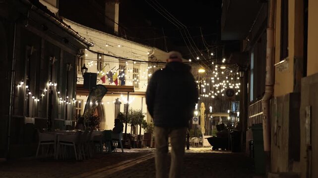 Cluj-Napoca A man walks at night in the Old Town  
