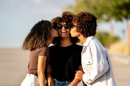 Three friends sharing a joyful moment outdoors