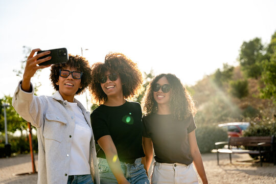 Friends taking a selfie outdoors on a sunny day