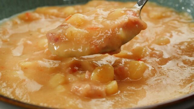 Split pea soup, Eating mashed pea soup with sausages and pork. Popular german or slavic food, winter street food.