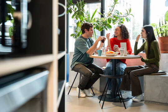 Multiethnic colleagues enjoying coworking lunch break