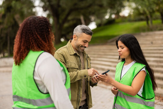 Multiethnic friends in city park promoting eco activities