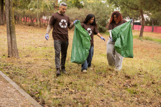 Multiethnic group cleaning park to support ecology