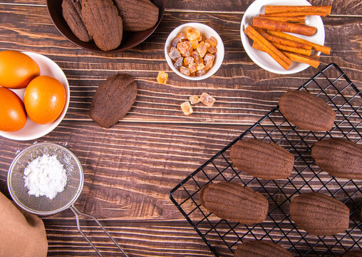 Chocolate madeleines on a wooden background