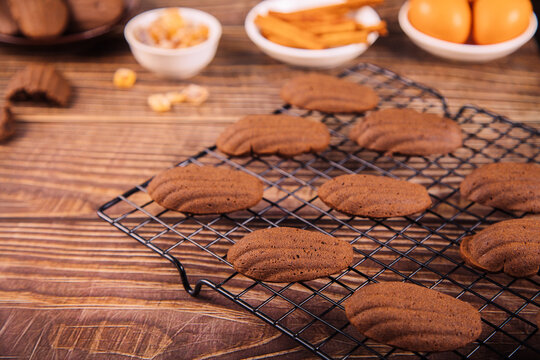 Chocolate madeleines cooling on baking rack