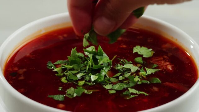 Beetroot soup, Cooking traditional national Slavic Russian, Ukranian soup Borsch close-up. Boiling red soup with vegetables and turkey meat and spices. Special red for Borsh from beet, tomatoes pasta