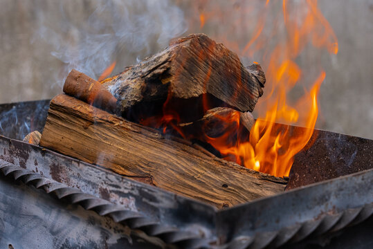 Wood burning in outdoor barbecue grill