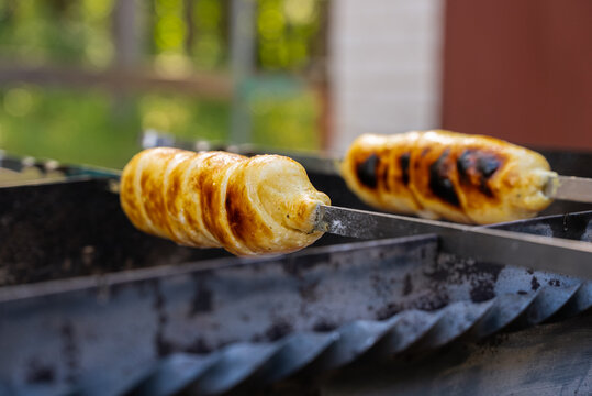 Grilled cheese skewer sizzling on grill outdoors