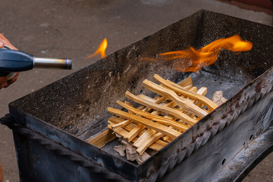 Preparing firewood for summer barbecue grilling