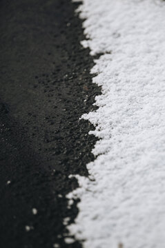 Snow on asphalt in winter creating contrast in Latvia