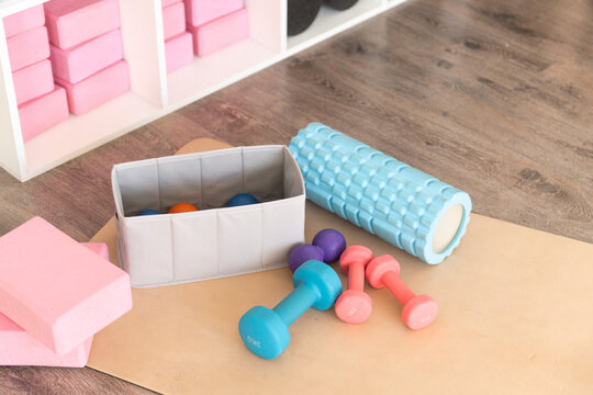 Exercise equipment and accessories on a wooden floor