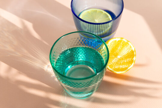 Refreshing lemon and water in colorful glasses