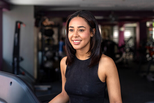 Fitness girl enjoying workout in modern gym