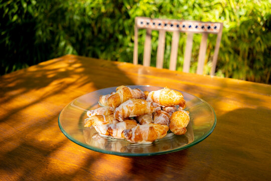 Little croissants on a glass plate outdoors