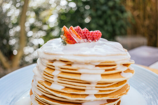Pancakes topped with strawberries and white chocolate