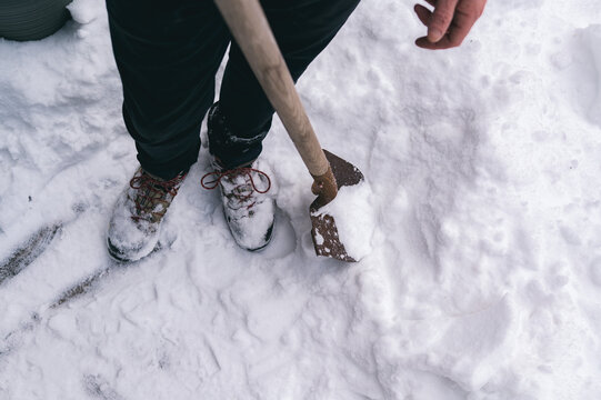 Shoveling snow on urban winter street