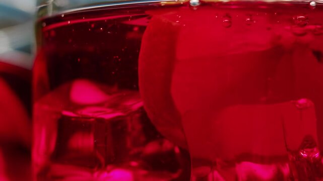 Vermouth Negroni, spanish wine drink, Alcoholic Americano Cocktail bitter, sweet vermouth and soda water, close up of making drink, summer spanish vacations. 