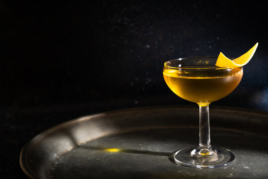 Elegant herbal liqueur with citrus garnish on tray