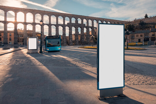 Ancient aqueduct with city bus and two billboards
