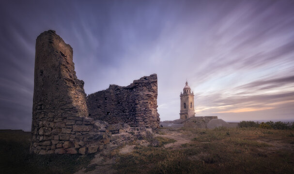 Ancient ruins and castle tower at sunset