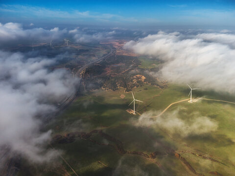 Aerial view of wind turbines on a green landscape