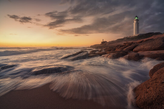 Scenic sunset view of Trafalgar Lighthouse and coast