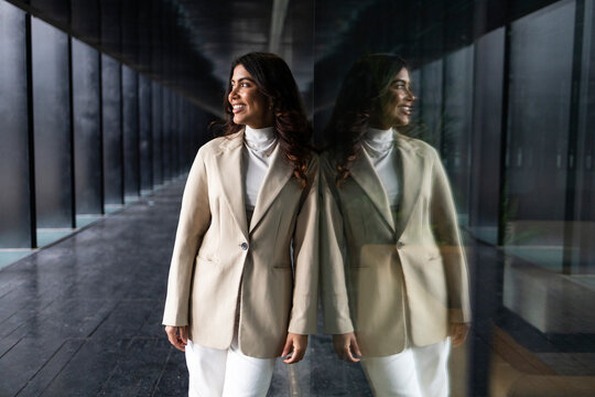 Professional woman in business attire by office window