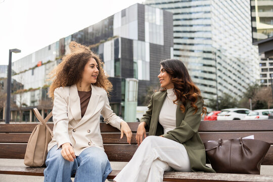 Women having a business meeting on a city bench