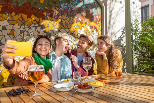 Friends enjoying tapas and capturing moments