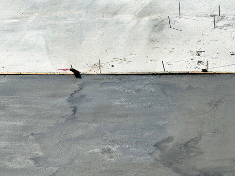 Concrete pouring at construction site with steel mesh