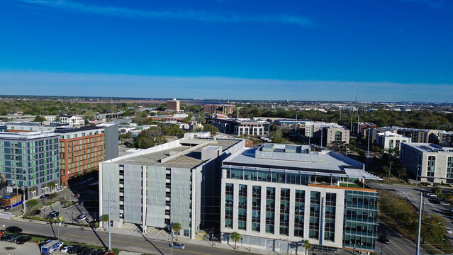 Mid rise buildings line Morrison Dr near NoMo district with palm lined streets and active parking areas. Glass reflections, clean rooflines, and balanced urban textures, Charleson, South Carolina