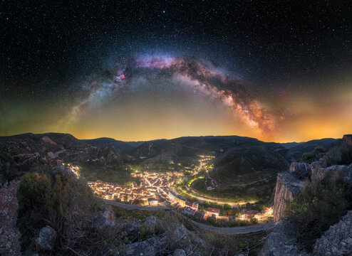 Milky Way Arch Over Illuminated Village of Sot de Chera, Valencia at Night