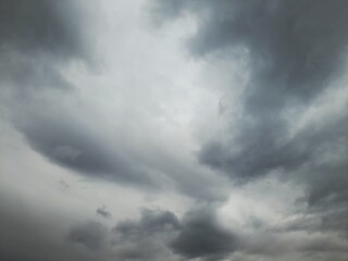 Fototapeta premium Dramatic storm clouds over dark sky, moody grey nimbus background, natural weather phenomenon