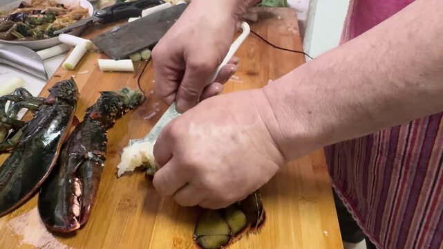 Preparing and cooking fresh lobster at home, with seafood arranged on a kitchen counter, capturing a hands-on home cooking process and authentic seafood preparation.