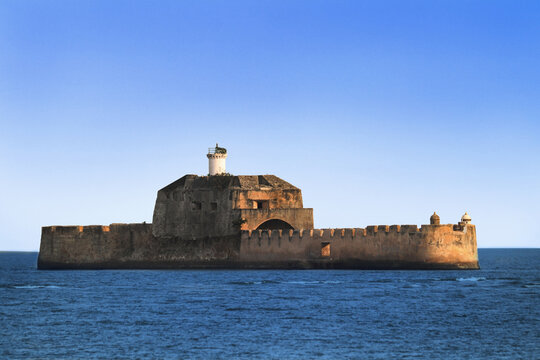 Pani Kotha prison in the distance. Shows the blue water, waves, ocean Walls of diu fort with view of Old Diu City, Portuguese, located in Diu district of Union Territory Daman and Diu India gujarat.