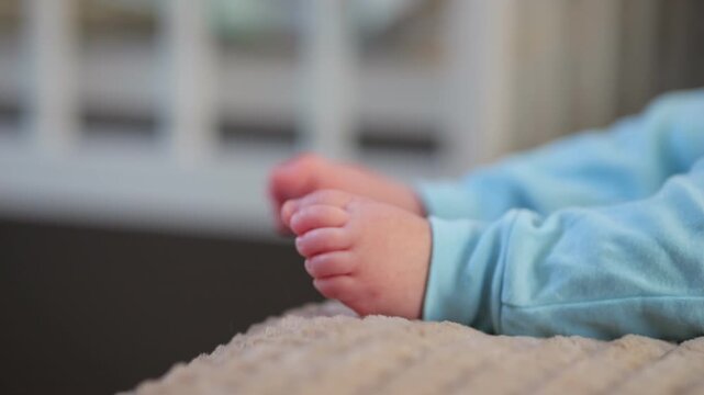 Child Stomps Toes. Young Kid Excitedly Kicks Small Toes. Baby Happily Rhythmically Strikes Tiny Toes On Bedding. Child Enthusiastically Kicks Small Toes While Lying Contentedly On Soft Blanket