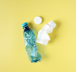 Plastic waste on yellow background, plastic recycling concept. Waste separation concept promoting recycling and environmental responsibility.