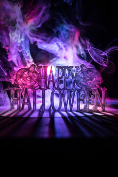 Halloween concept. Creepy silhouette in the dark corridor with pumpkin head. Toned light with fog on background.