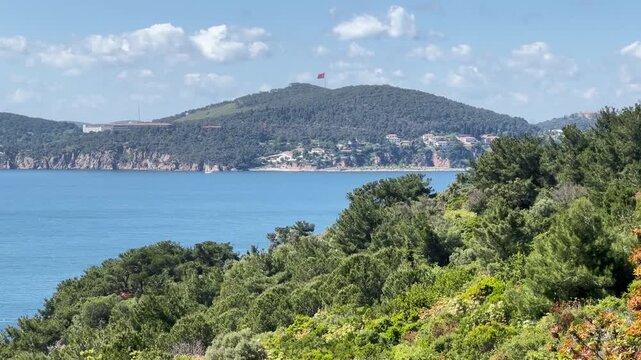 View of Heybeliada from B&uuml;y&uuml;kada, capturing serene, coast atmosphere, natural life and green vegetation of Istanbul Prince Islands. Zoom out
