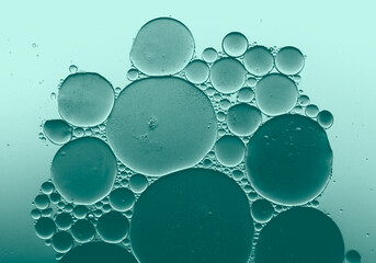 Abstract blue green oil bubbles in water, macro liquid background © Melody