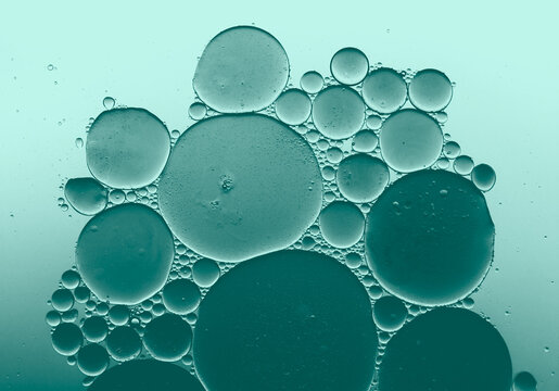 Abstract blue green oil bubbles in water, macro liquid background