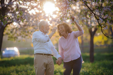 Beautiful senior couple in love on date in spring nature.
