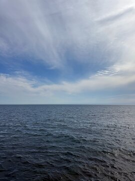 Open sea dark blue waters and cloudy sky.