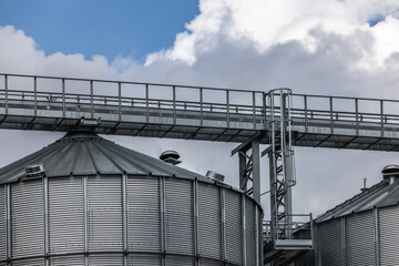 Metal grain silo structure for agricultural storage. Industrial steel construction used for storing grain and crops, photographed outdoors with a focus on farming, industry and rural infrastructure.