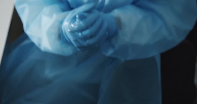 Laboratory worker disinfecting hands in Corona testing lab in Berlin