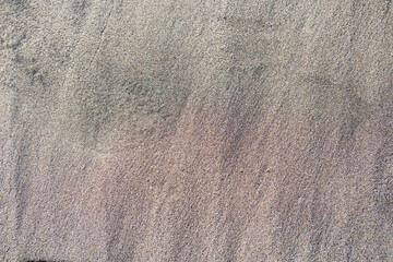 Textura de arena húmeda de playa con tonos grises y rosados, fondo natural de costa chilena  © veronica