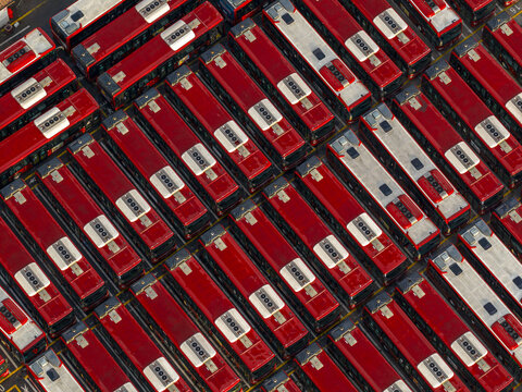 Aerial view of a dense grid of parked red and white buses creating a rhythmic pattern of color and form, Rome, Lazio, Italy.