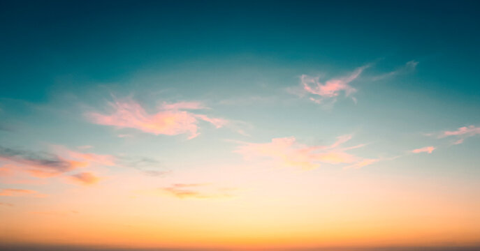 Pastel sunset sky panorama with pink and orange clouds, sky replacement background banner with copy space