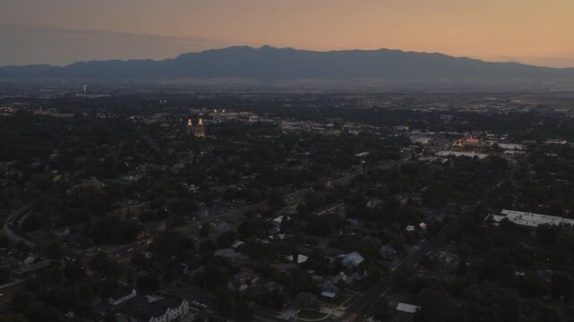 An aerial flyover of Logan, UT at dusk